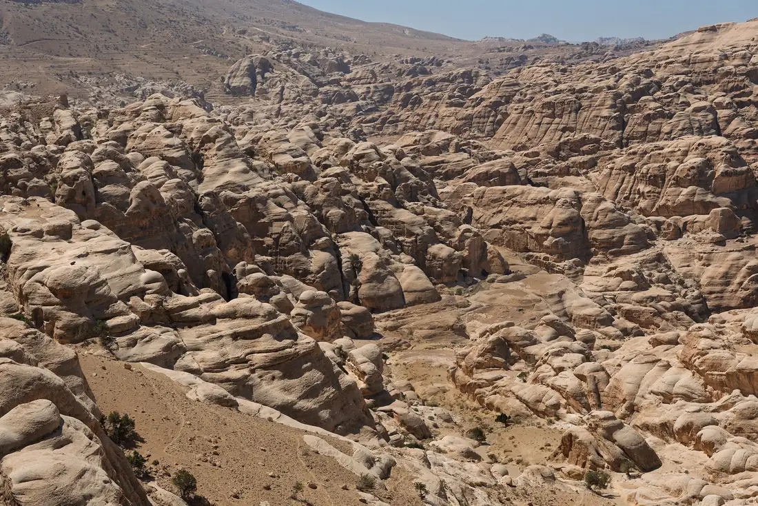 The sandstone valley of Petra seen from above, with rugged rose-coloured rock